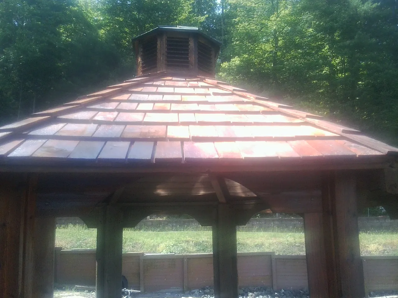 New cedar shake roof and cupola on a lakeside gazebo in Stockertown