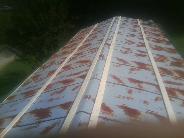 Rusted metal roof panels with new wood purlins before replacement — Storm Damage Roof Repair in Stockertown by Roofing Brothers